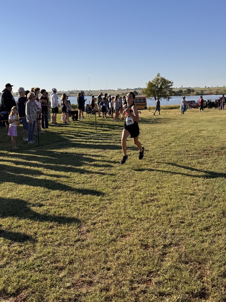 Navajo cross country students crossing the finish line.