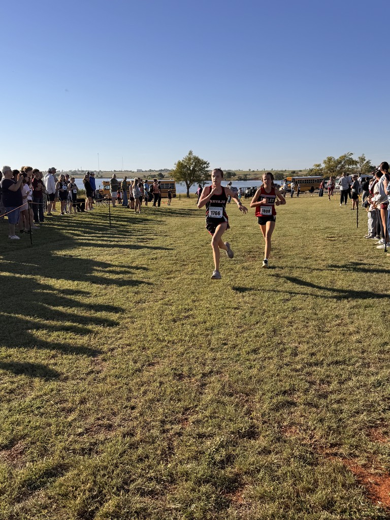 Navajo cross country students crossing the finish line.