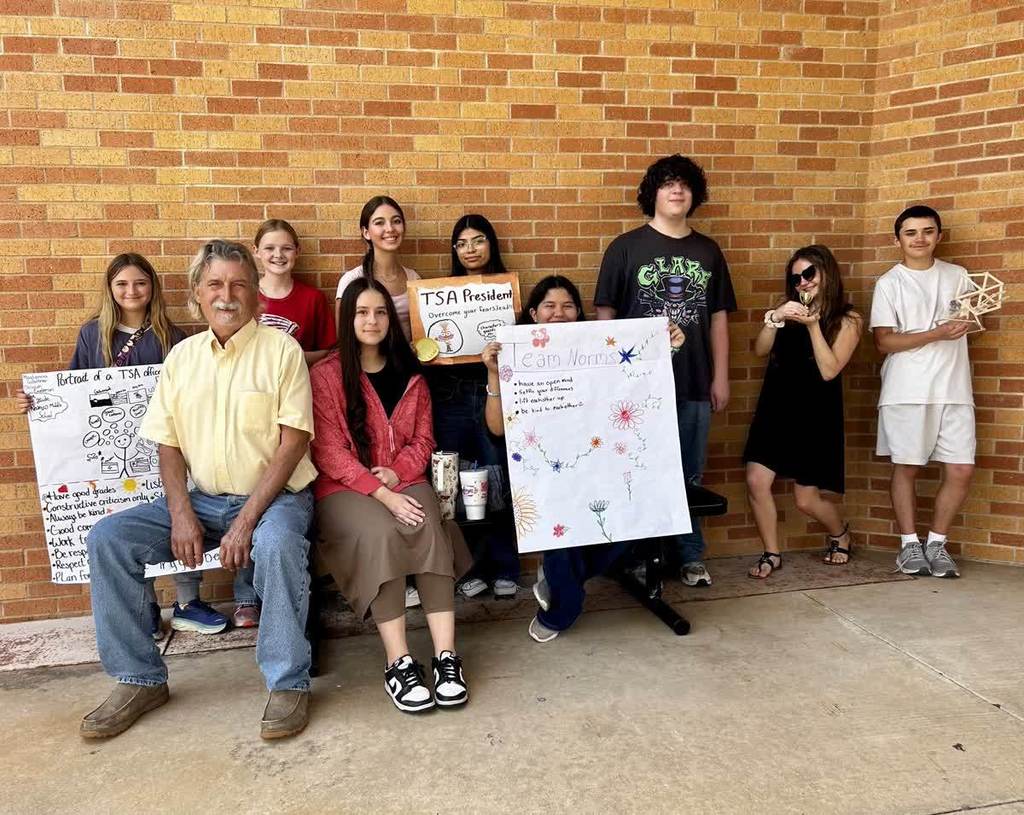 TSA members holding signs at a conference they attended