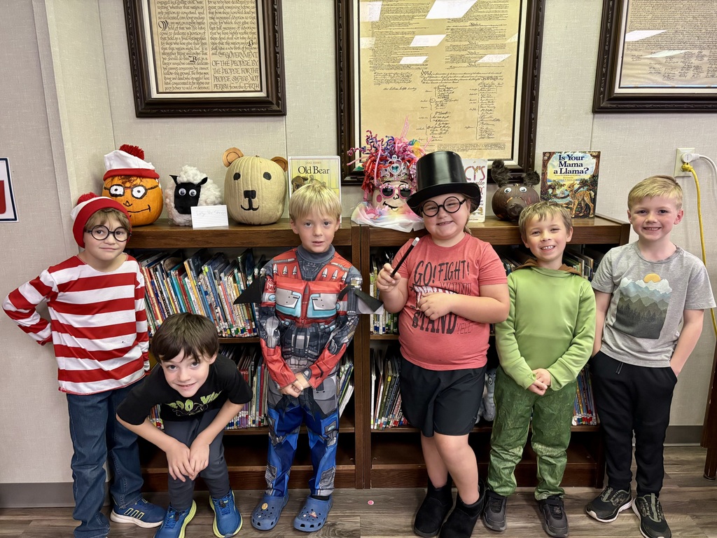 1st grade students with decorated pumpkins.