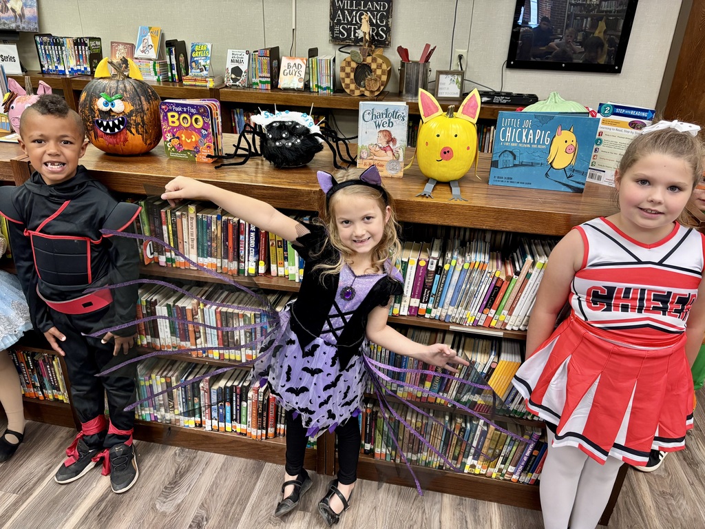 1st grade students with decorated pumpkins.