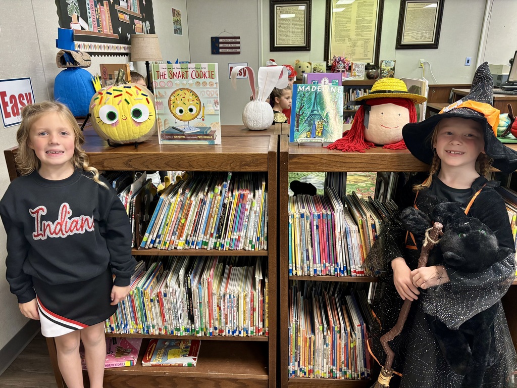 1st grade students with decorated pumpkins.