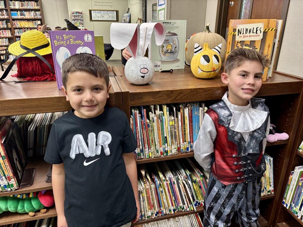 1st grade students with decorated pumpkins.
