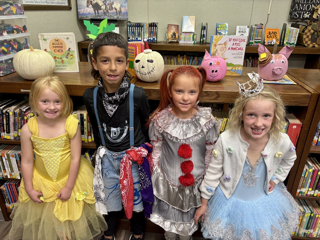 1st grade students with decorated pumpkins.