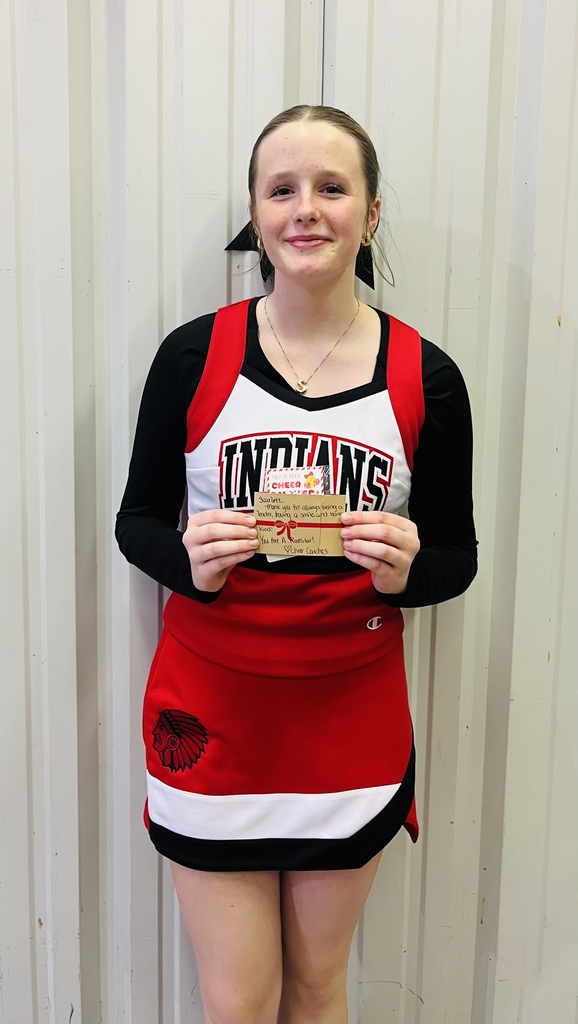 Cheer Leader of the week holding a small note