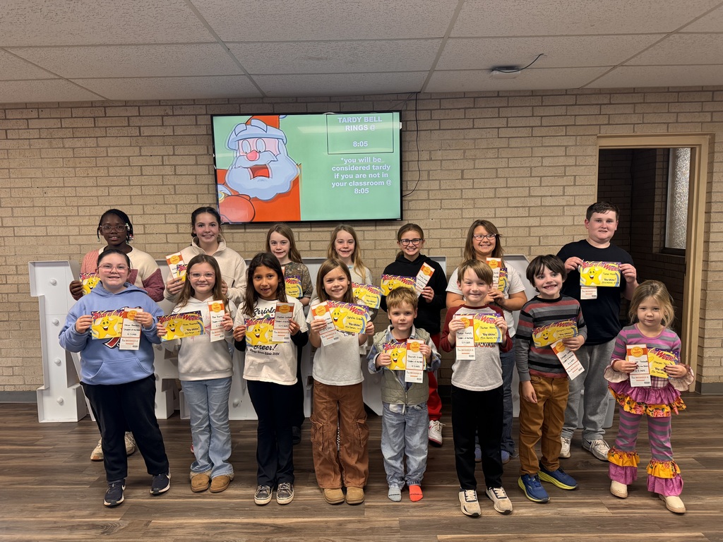 Studnets of the week lined up in the lobby holding a certificate
