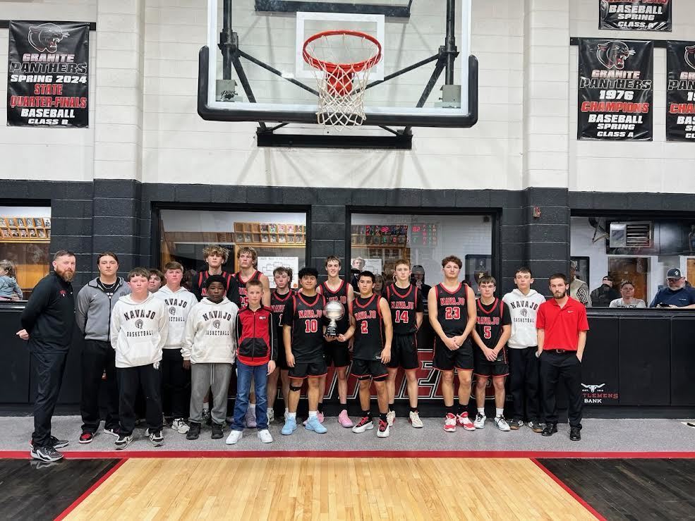 Boys basketball team holding a silver 2econd place trophy