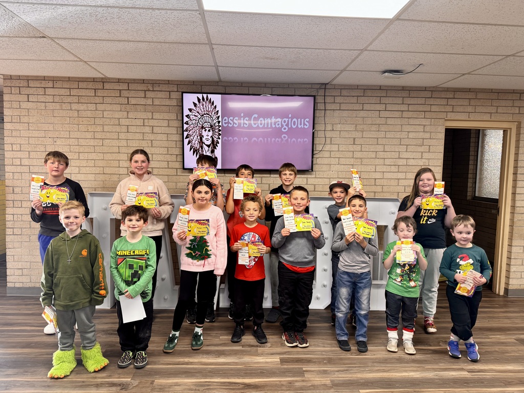 Students of the week holding their certificates