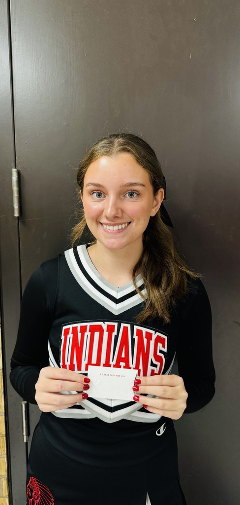 Cheerleader of the week holding a cerificate