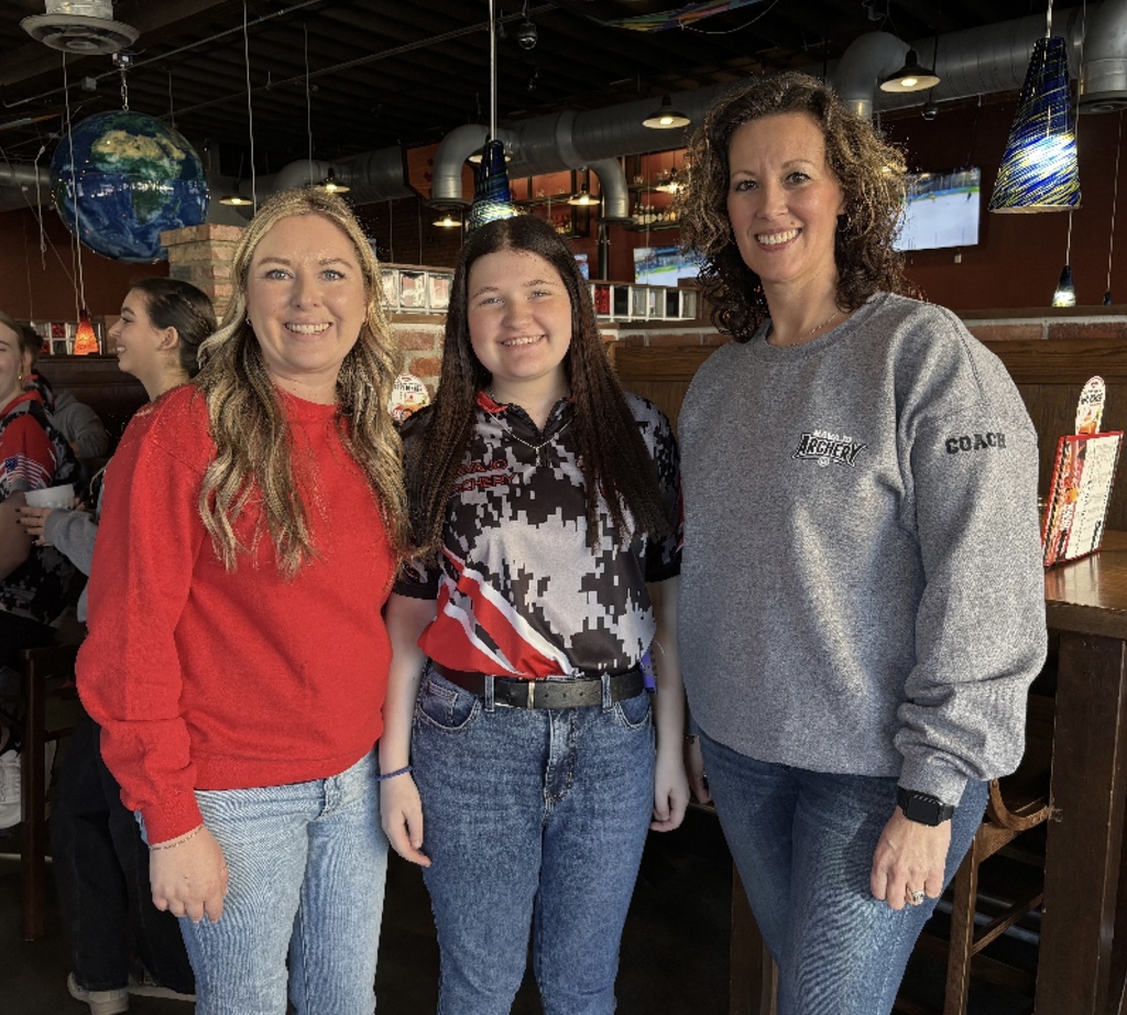 Coaches standing with Kayla English