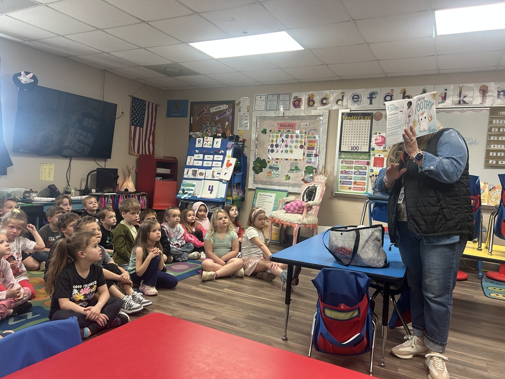 dental worker reading to students 