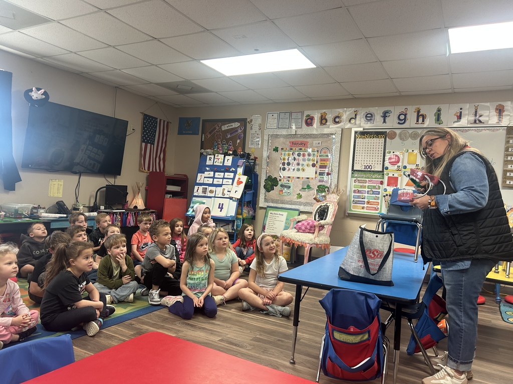 Students watching a dental workers presentation in their classroom