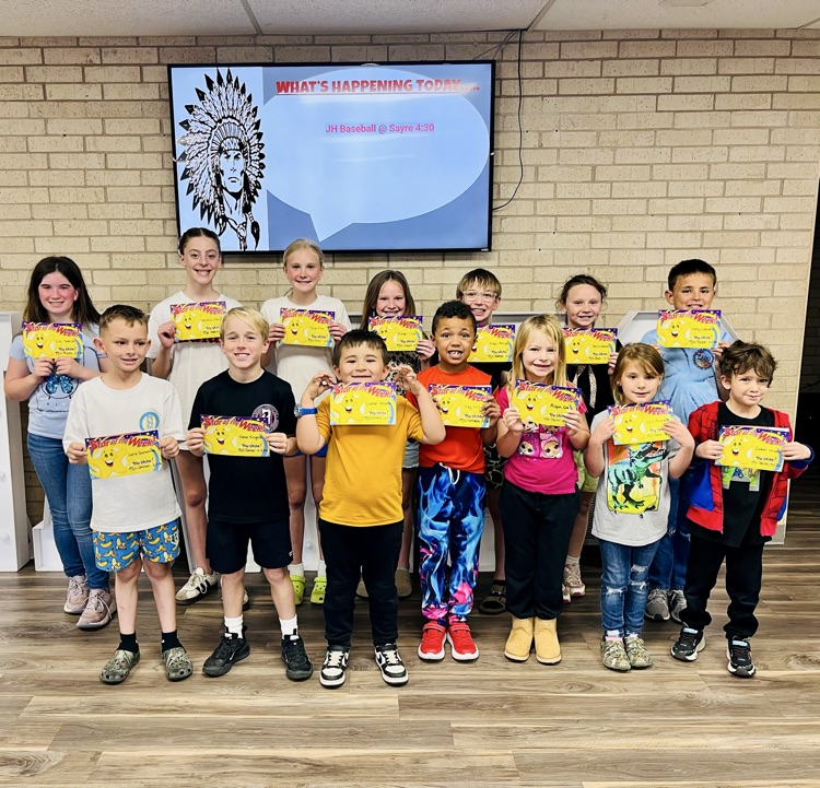 students standing with their certificates in front office  