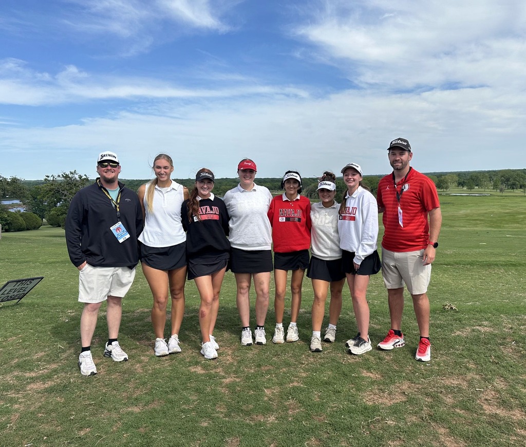 Golf team posing with coach kale