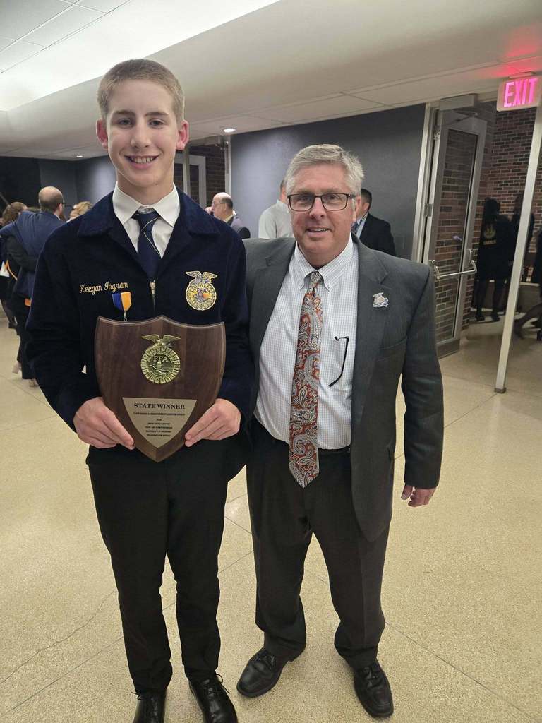 Keegan standing with event official