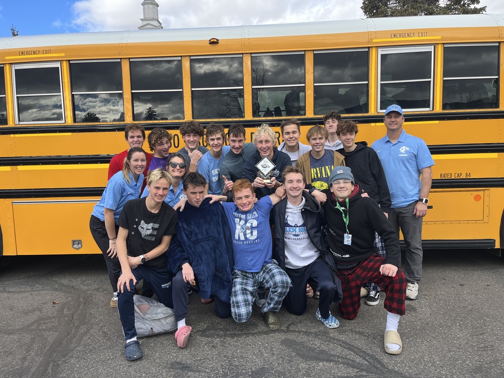 Salem Swim team in front of school bus