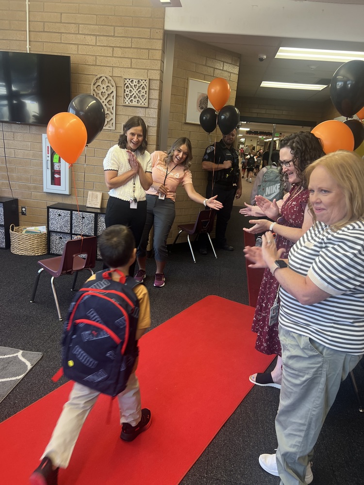 student walking into school on the red carpet