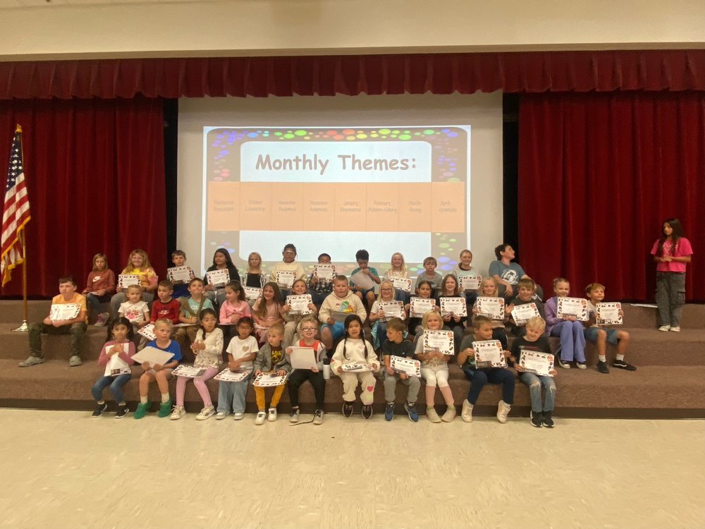 kids on stage with certificates
