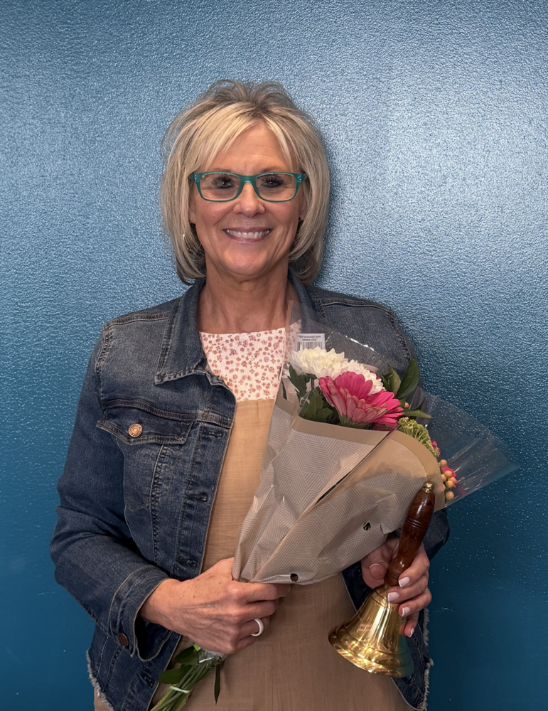 Kim Head holding flyers for Secretary of the Year Award