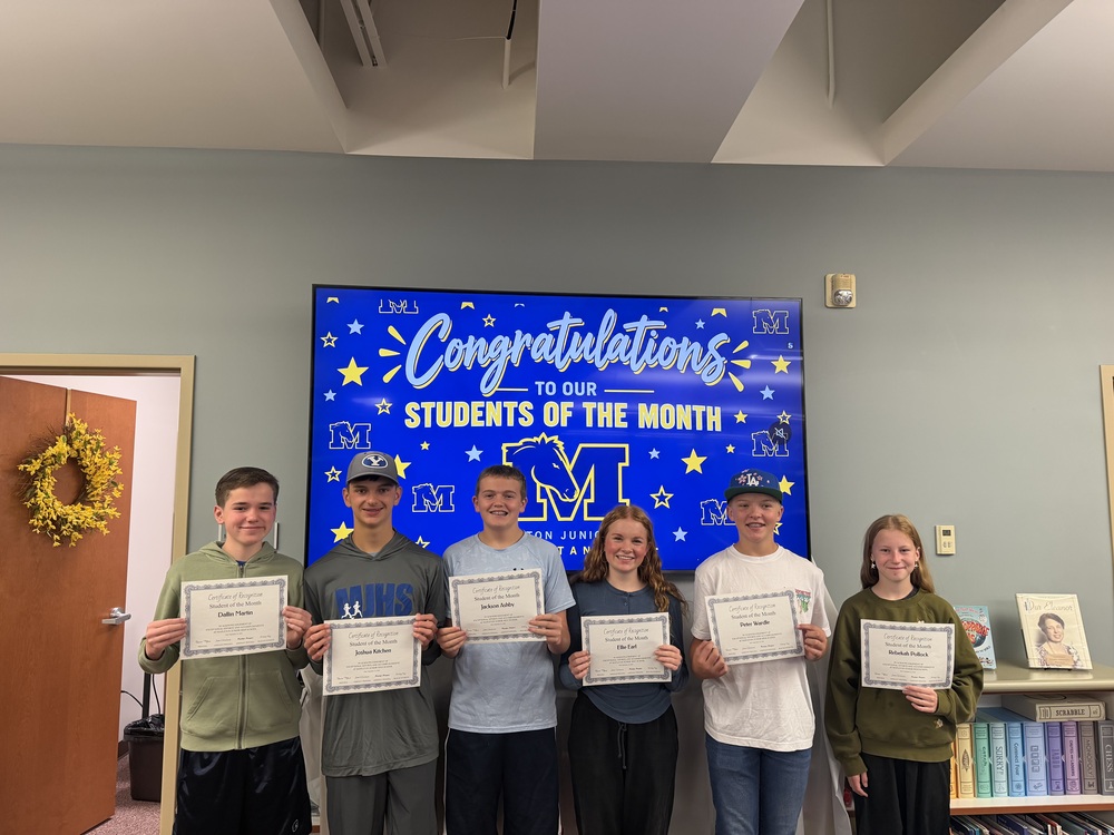 Students of the month holding up their certificates 