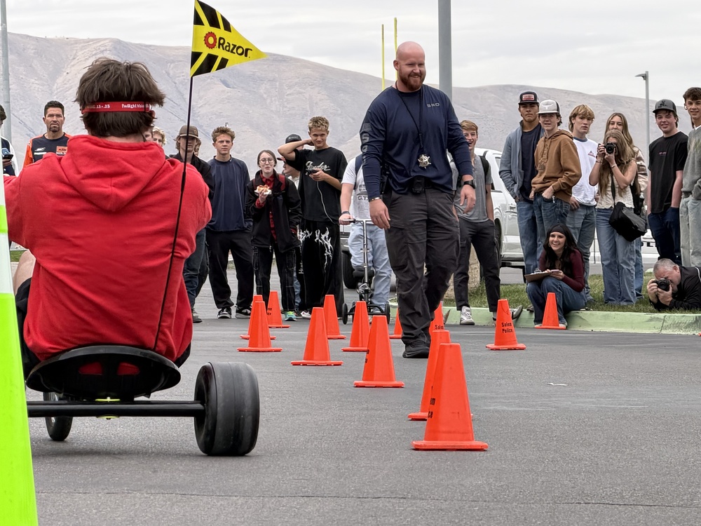 Pizza with the Police Lunchtime Activity- students riding bikes with drunk goggles