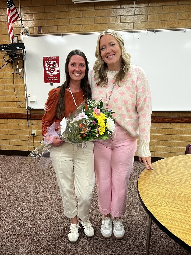 teacher of the year and principal standing in the faculty room