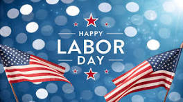 Flags flying with the word happy labor day.