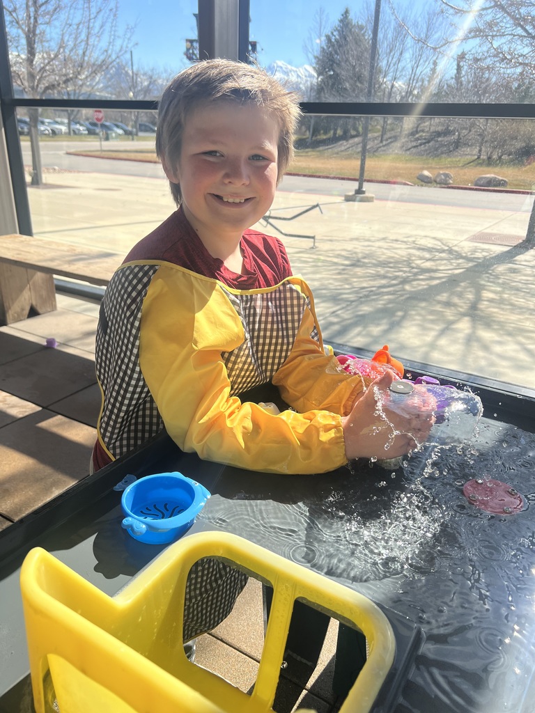 student playing with water