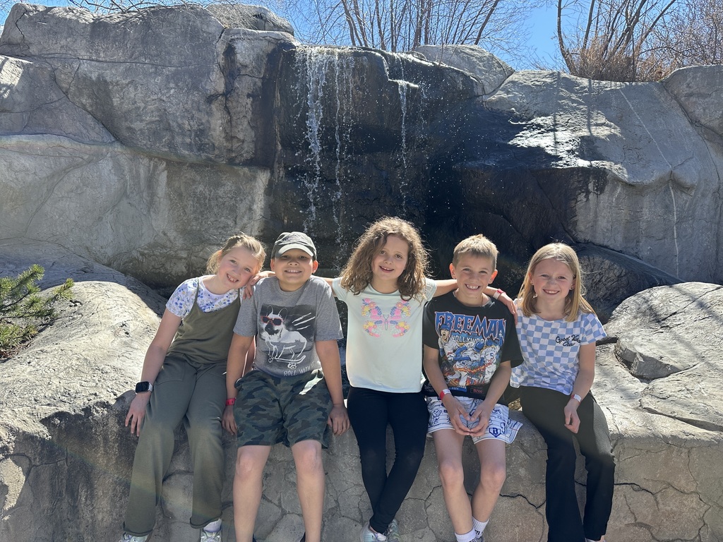 students posing on the rocks