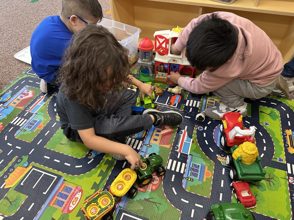 students playing with farm toys