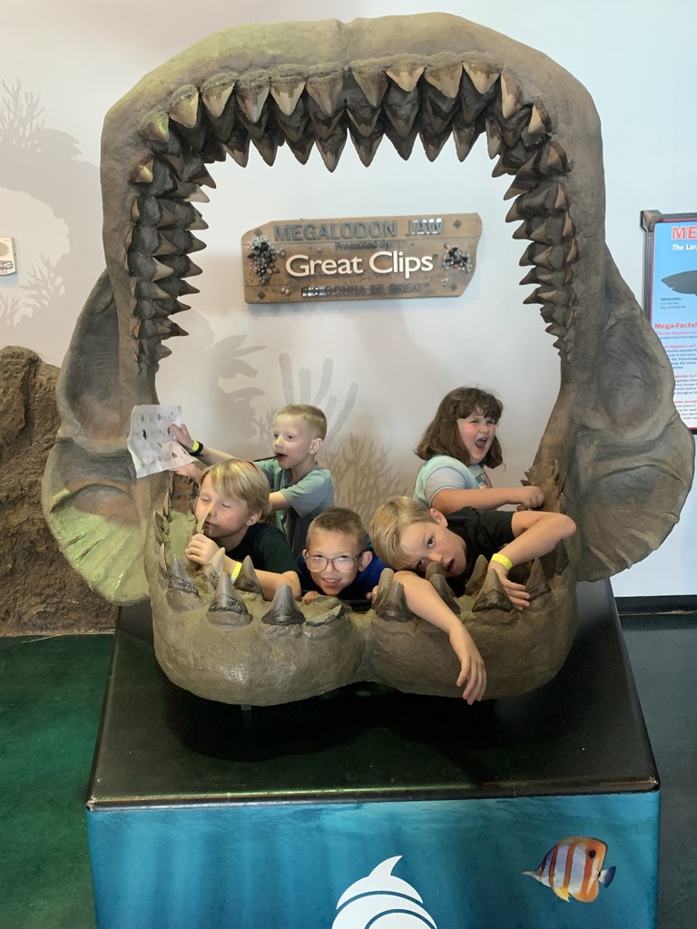 students posing in a shark jaw