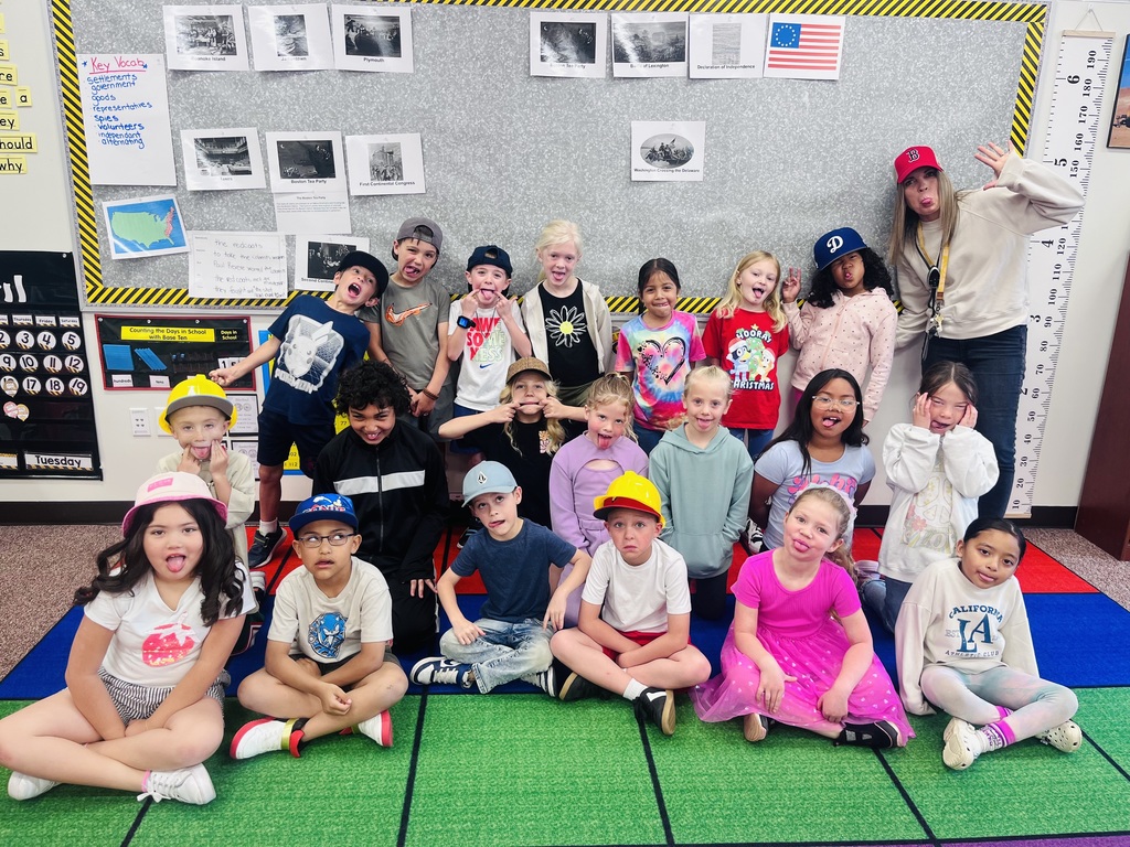 students posing in a photo wearing hats