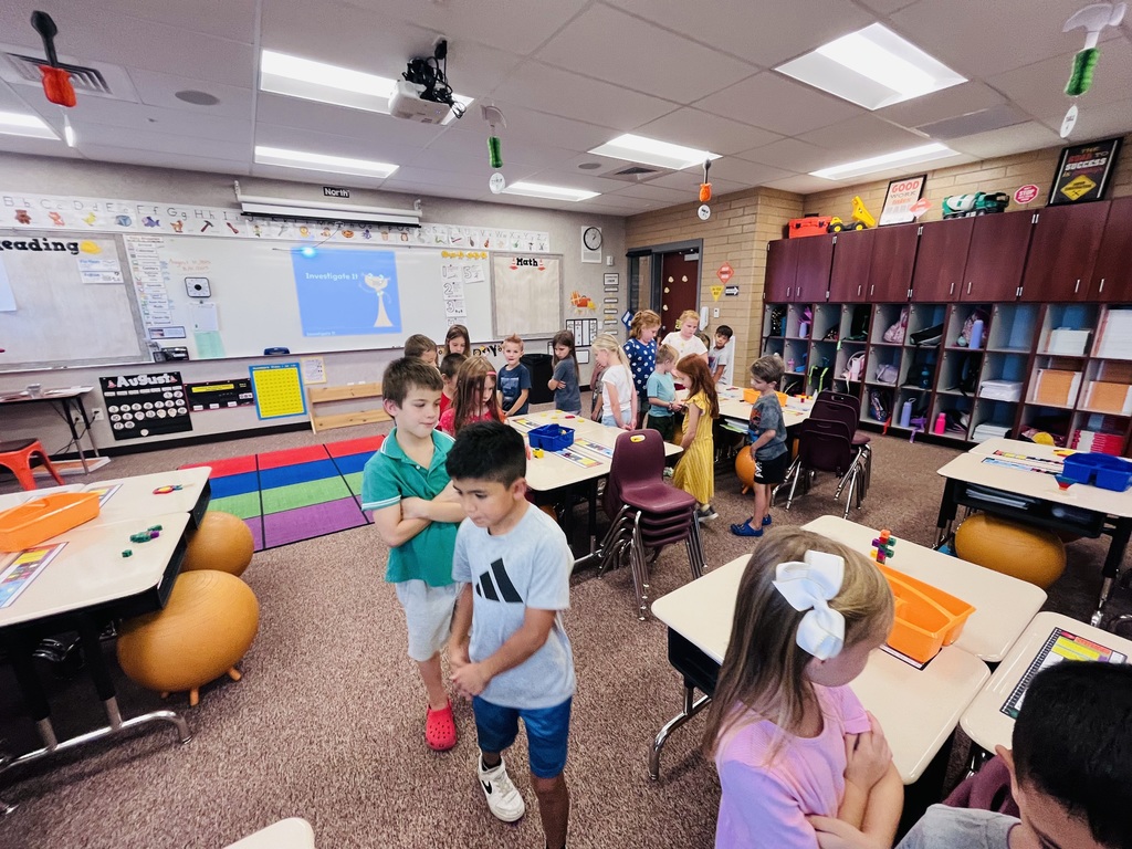 first graders walking around desks