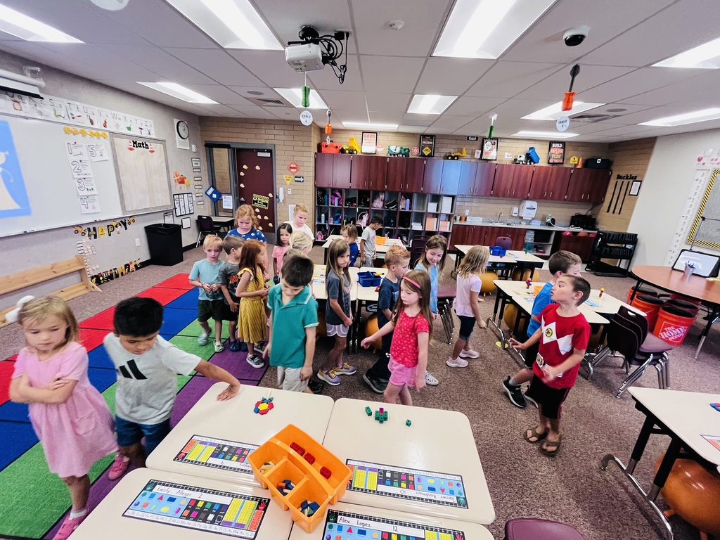 first graders walking around desks