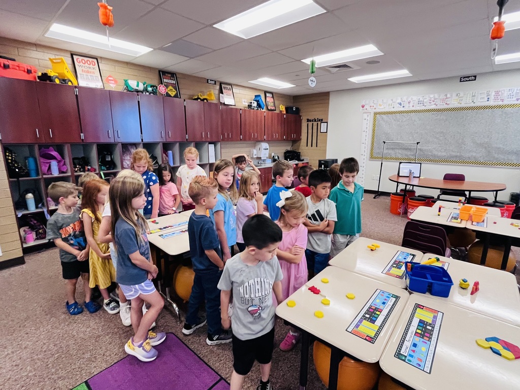 first graders walking around desks