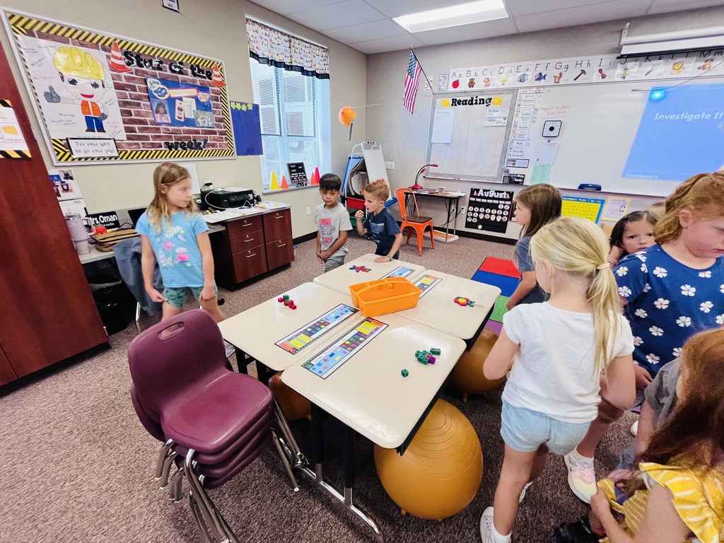 first graders walking around desks