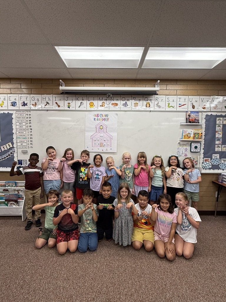 class photo with kids holding friendship bracelets