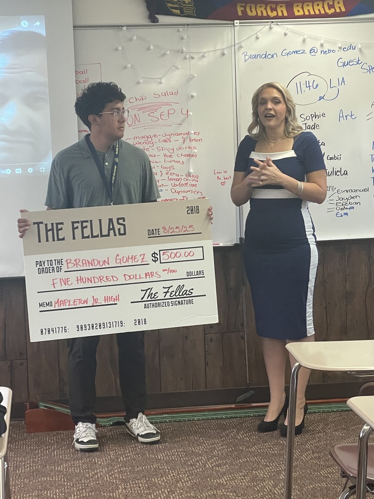 Brandon Gomez with Fellas Barbershop receives check for $500