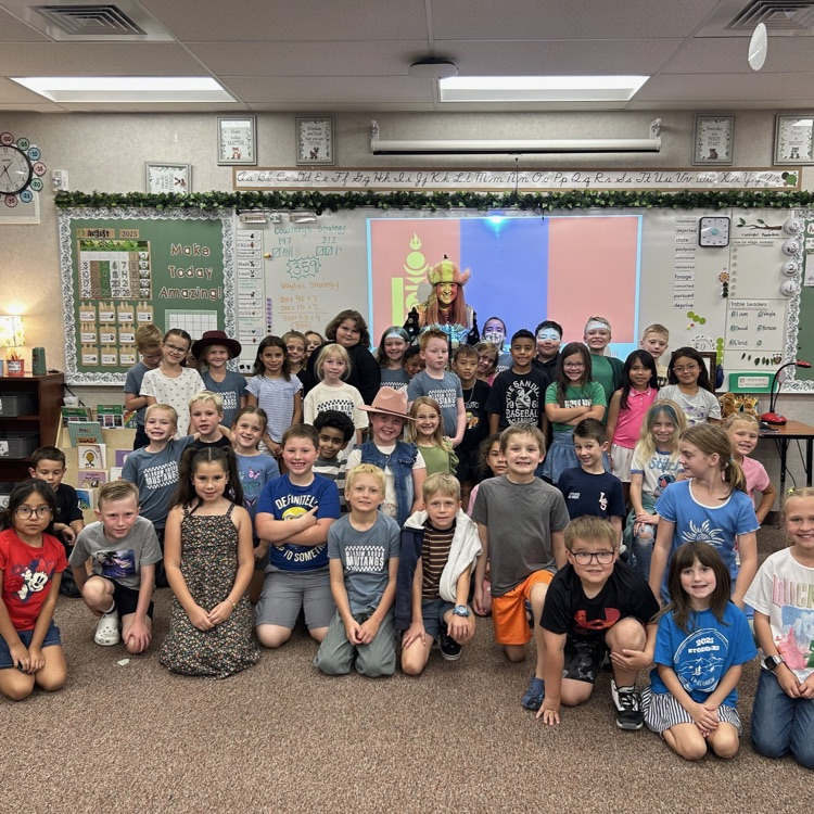 students posing in front of whiteboard