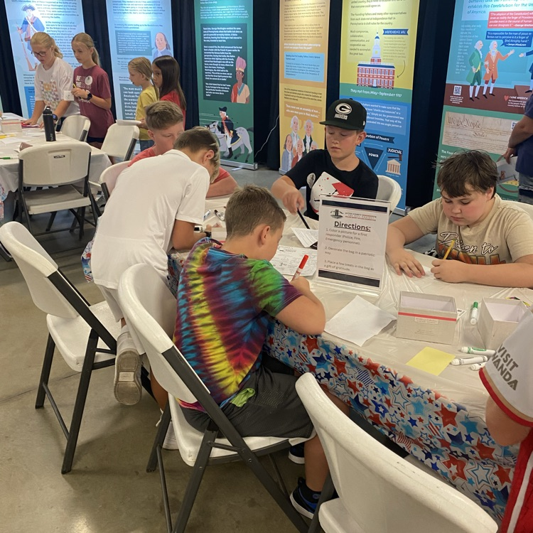 students sitting at a table writing notes to first responders 