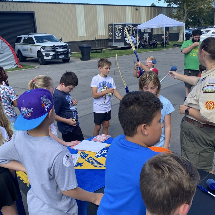 students learning about archery from the Boy Scout organization 