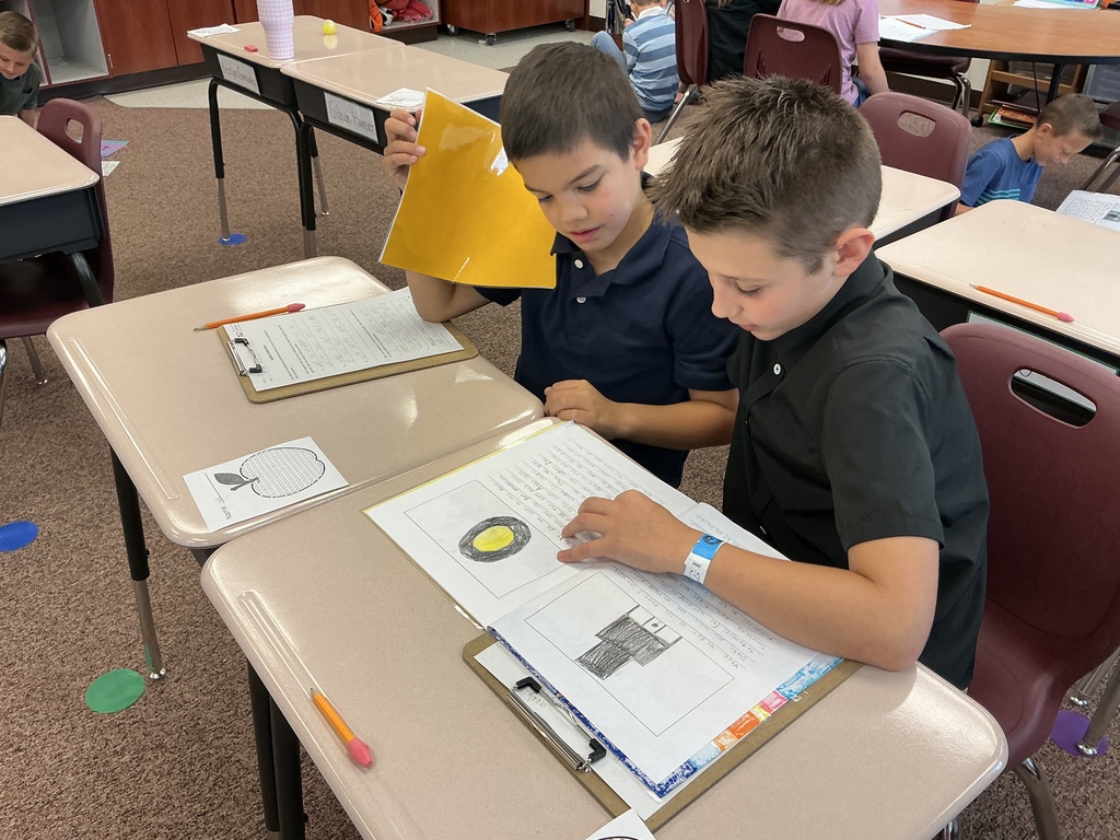 Students reading their story to a partner.