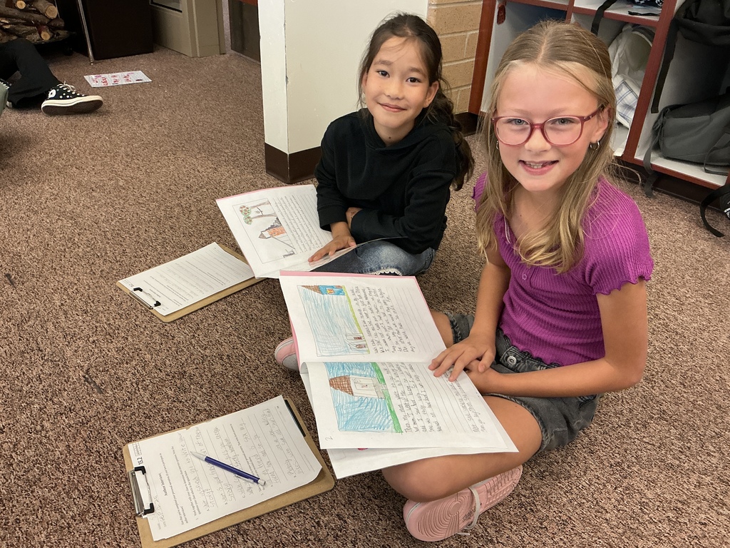 Students reading their story to a partner.