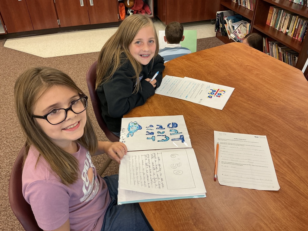 Students reading their story to a partner.