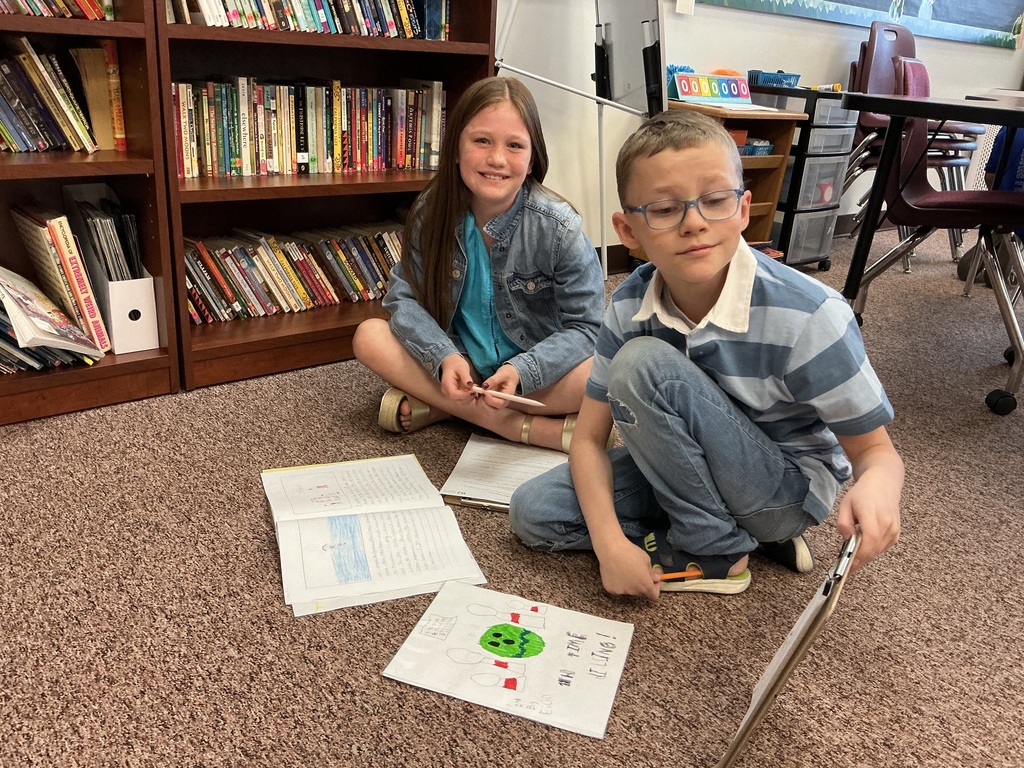 Students reading their story to a partner.