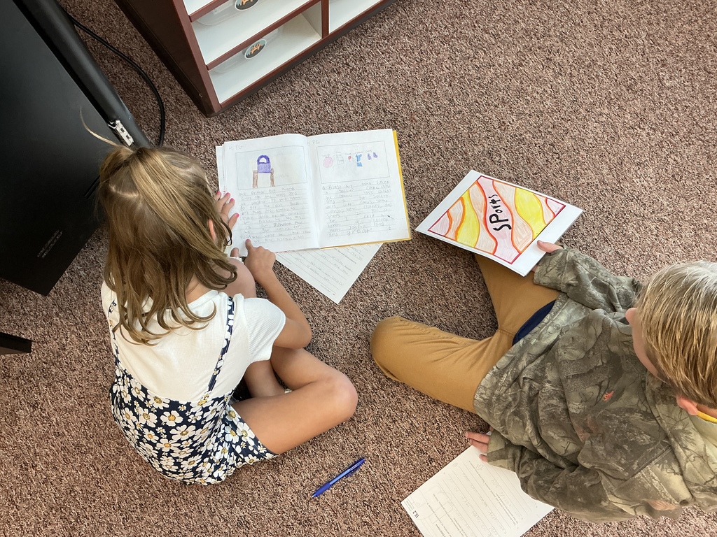 Students reading their story to a partner.