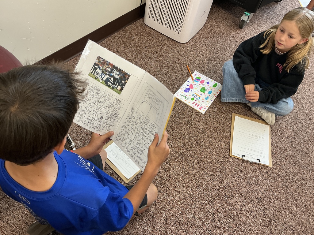 Students reading their story to a partner.