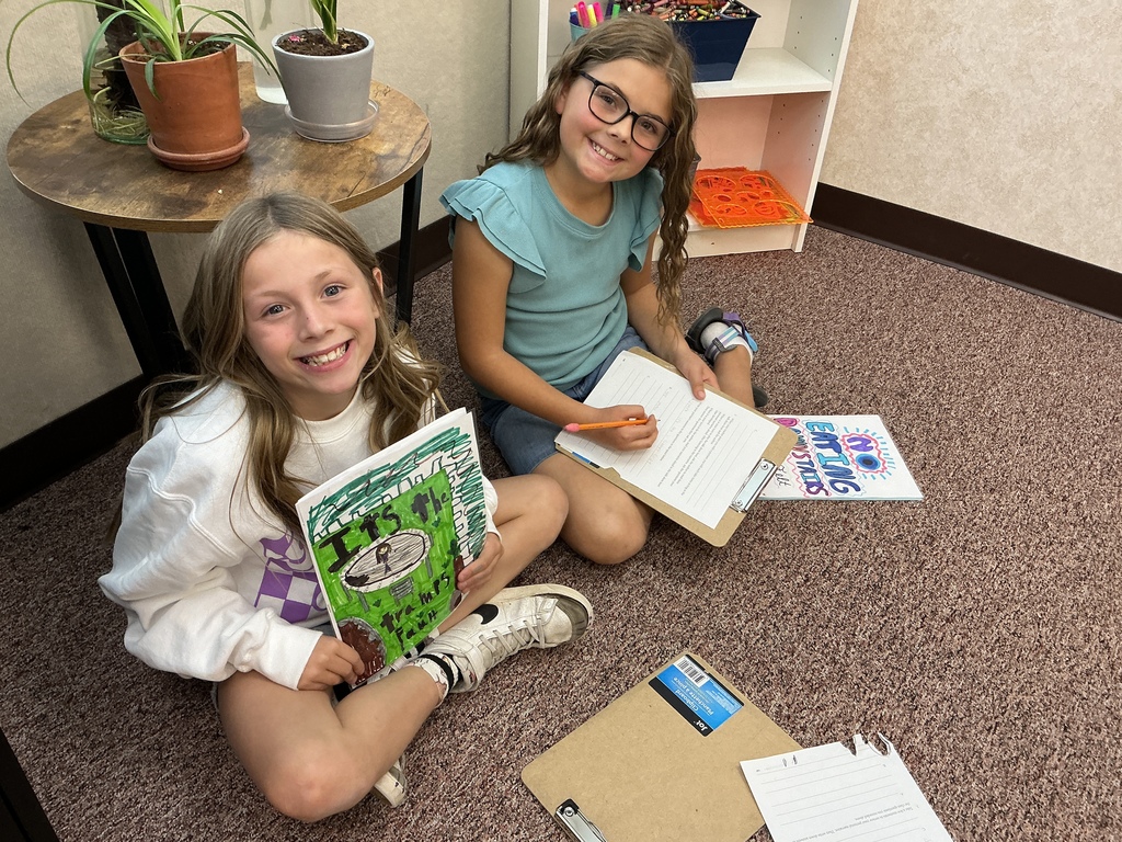 Students reading their story to a partner.