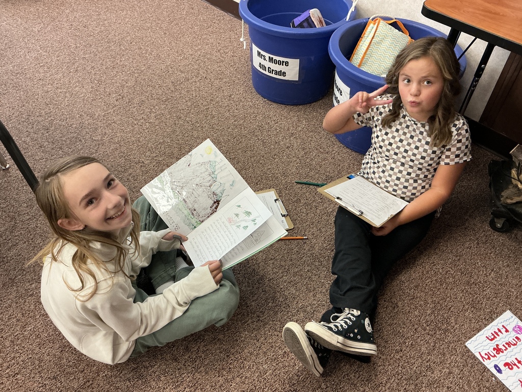Students reading their story to a partner.