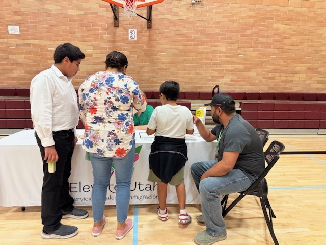 Vendor helping a student and family at back to school night